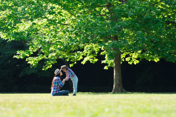 istock Mother and daughter playing on the lawn 961885746