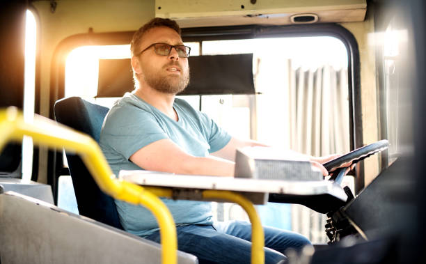 istock Focused and a bit worried bus driver is checking his side mirrors before switching lanes. 961892372