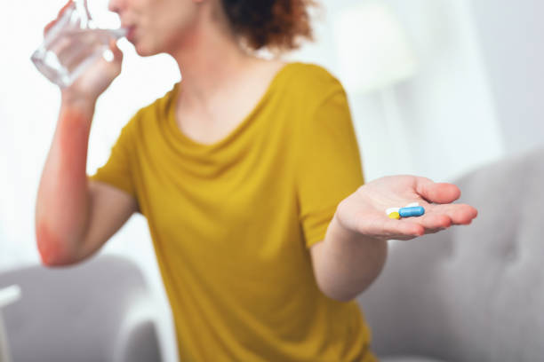 istock Young lady taking vitamins for her health 961893614