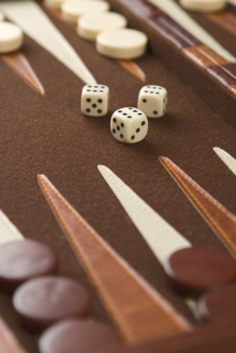 Backgammon board with dice and checkers on triangles