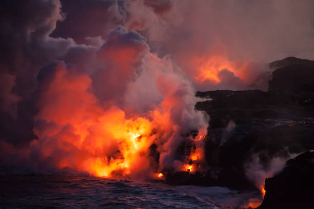 istock Glowing Lava Entering Ocean at Night 961894556