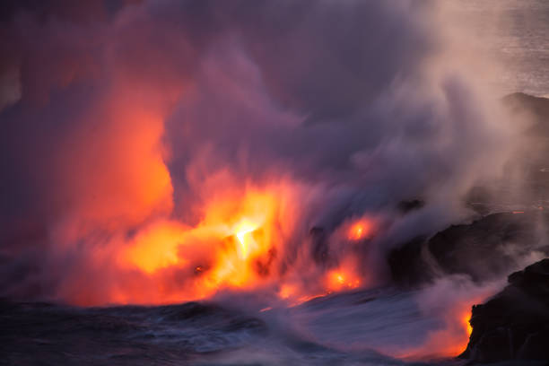 istock Glowing Lava Entering Ocean at Night 961894562