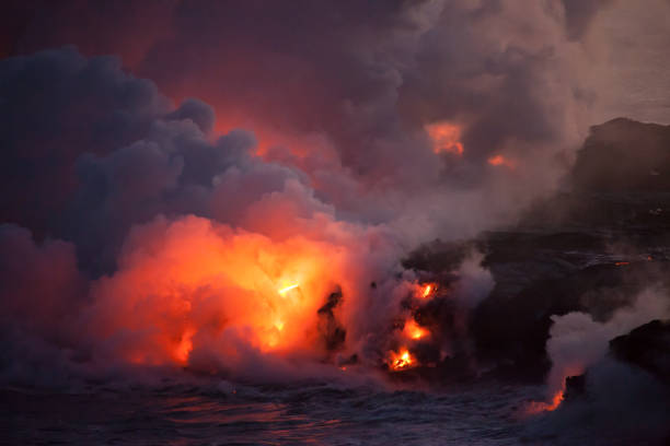istock Glowing Lava Entering Ocean at Night 961894924