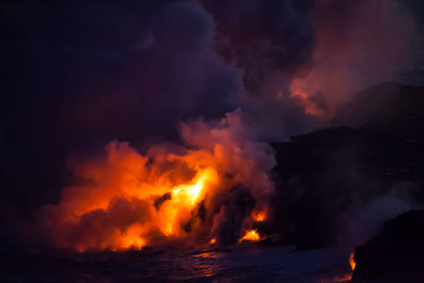 istock Glowing Lava Entering Ocean at Night 961896842