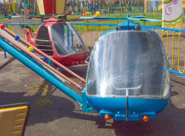 Carousel helicopter toys in an empty amusement Park in spring.