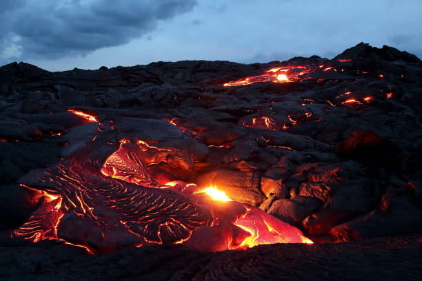 Glowing orange lava flow on Big Island, Hawaii Lava glowing hot orange as it flows down from Kilauea, Volcano on Big Island volcanic landscape stock pictures, royalty-free photos & images