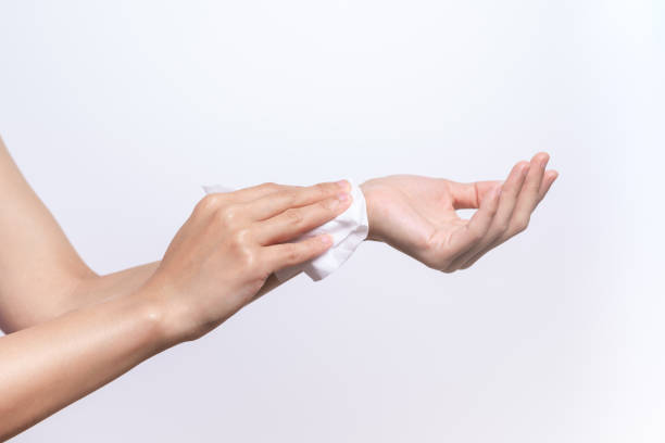 istock Woman cleaning her hands with white soft tissue paper. isolated on a white backgrounds 961900562