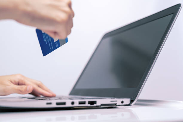 istock Hands holding credit card and using laptop. Online shopping 961902170
