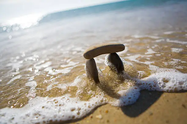 Small Stonehenge at sand near the sea