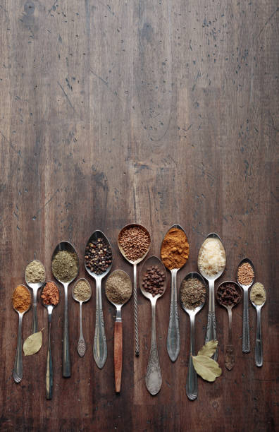 istock Different spices in  spoons on a wooden background. 961903516