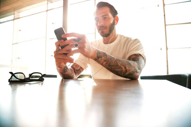 istock Man using smart phone with ear phones 961913726