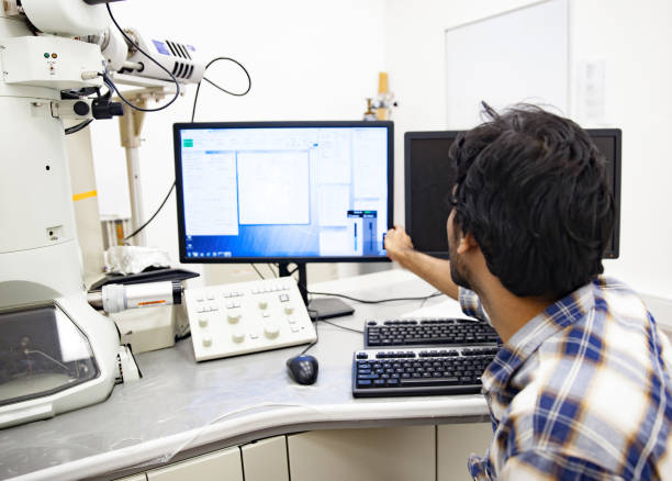 istock Young Scientist Adjusting Computer Monitor in Laboratory 961914948