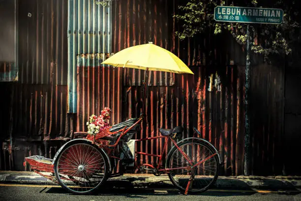 trishaw with yellow umbrella at the back street in penang