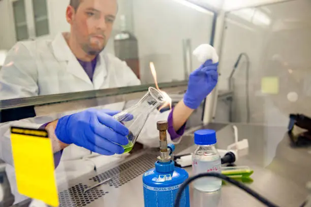 Photo of Biochemist Performing an Experiment in Controlled Environment in Laboratory