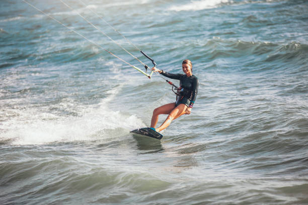 istock Kite surfing girl riding waves 961916196