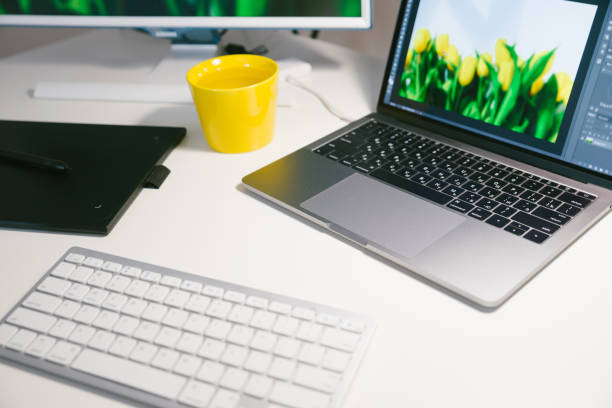 istock workplace, white desk with yellow cup and laptop on it 961916618