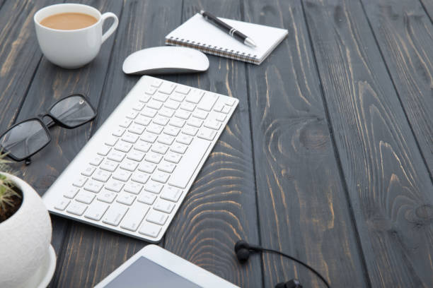 istock Modern workplace with smartphone and keyboard copy space on wood background. Top view. coffee cup. 961923094