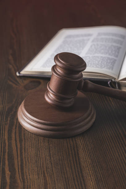 istock opened juridical book with hammer on wooden table, law concept 961923820