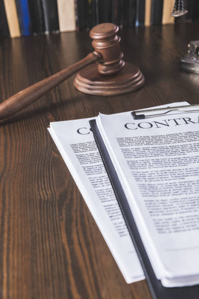 istock juridical contract on wooden table with hammer , law concept 961924114