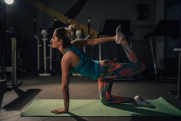 istock Woman stretching and enjoying yoga class in the studio 961924442