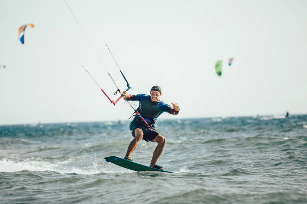 istock Athletic man riding on kite surf board 961926788