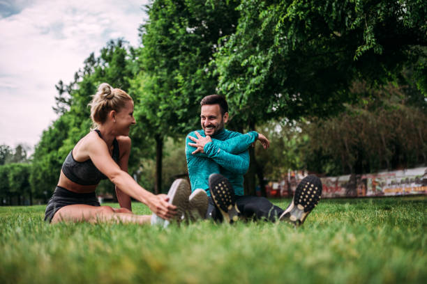 istock Couple warming up before run in the park. 961928302