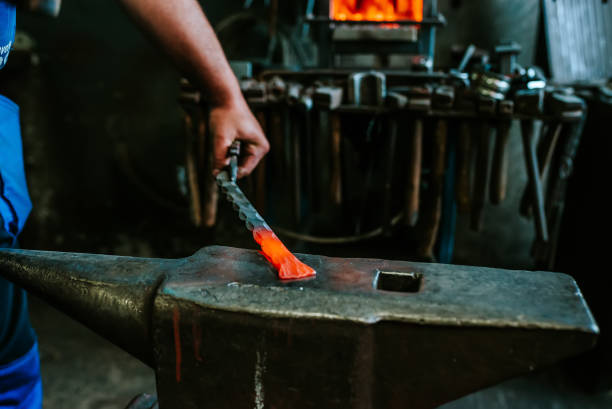 istock Forging red-hot iron with hammer on anvil. 961928622