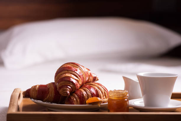 istock Tray with breakfast on a bed in hotel room 961928786