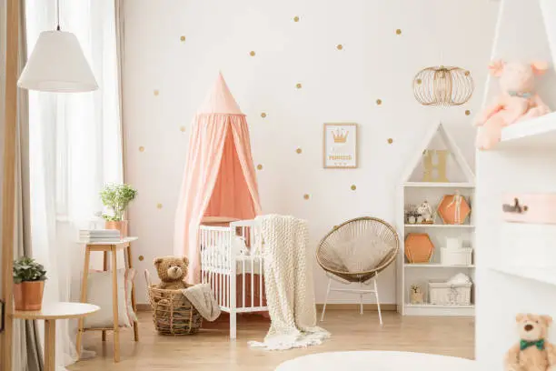 Photo of Gold and pink baby's bedroom