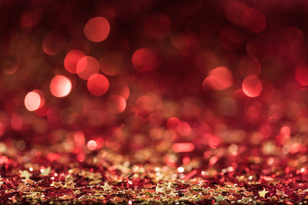 istock christmas background with red shiny confetti stars 961934138