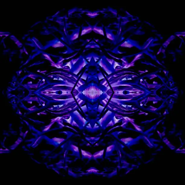 Abstract purple and blue texture; formed in round shape as a symmetrical monster face in the dark with center light.