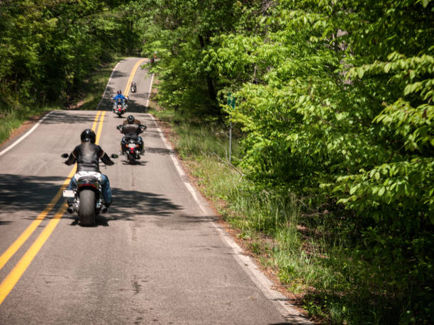 A motorcycle group ride through the countryside. Group ride through country roads. motorcycle group stock pictures, royalty-free photos & images
