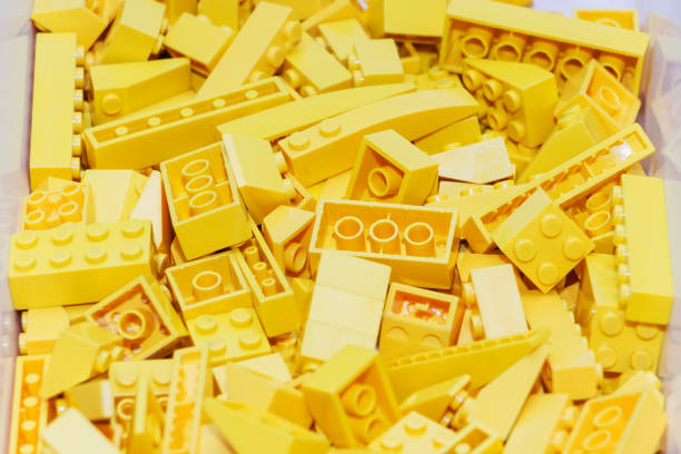 istock Yellow plastic building blocks designer. Background of bright plastic building blocks. 961940424