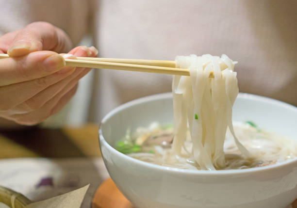istock Woman eating Vietnamese classic noodle soup. 961944752