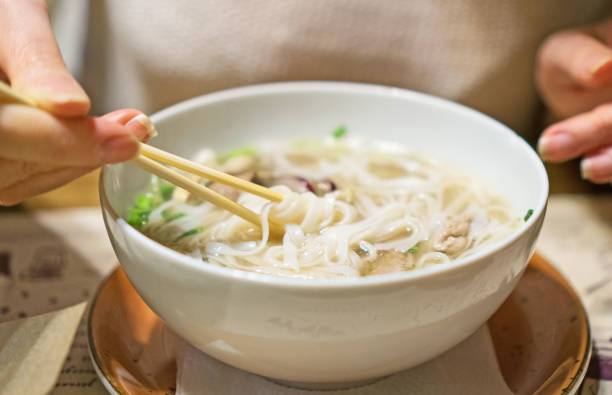 istock Woman eating Vietnamese classic noodle soup. 961944766