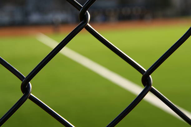 Game Throught a Fence  outfield stock pictures, royalty-free photos & images