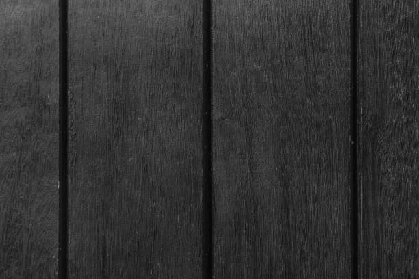 istock Monochrome Abstract Background texture of wooden decking with parallel planks with gaps 961953310