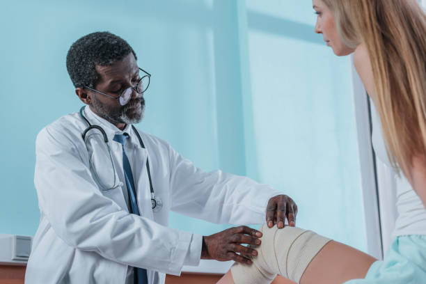 istock doctor putting on elastic bandage 961954256