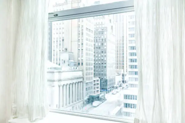 Photo of Window blinds curtains with view looking at midtown New York City NYC cityscape skyline in Manhattan hotel, apartment condo high rise building