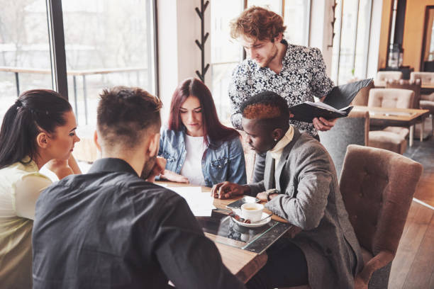 istock Group of casually dressed businesspeople discussing ideas. Creative professionals gathered for discuss the important issues of the new successful startup project. Teamwork Brainstorming Concept 961960820