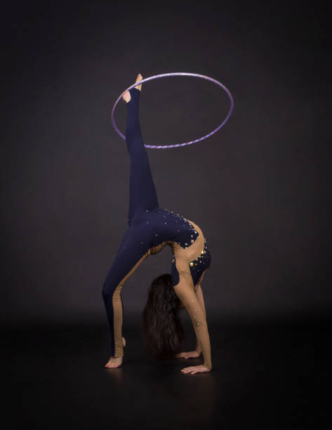 istock Gymnastic exercises with hula Hoop girl performs a circus artist. 961961598