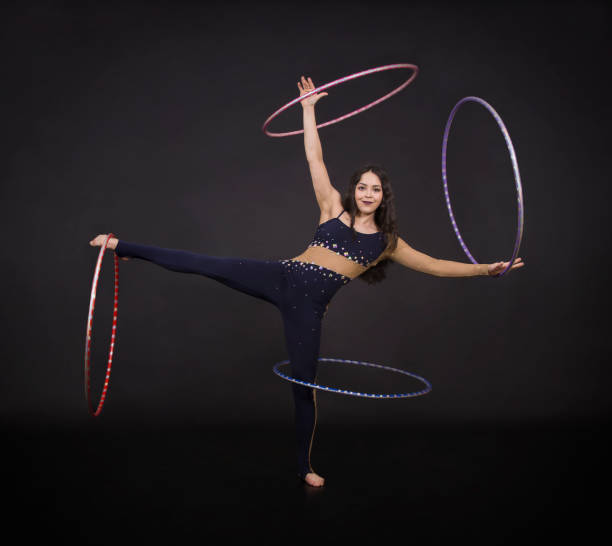 istock Gymnastic exercises with hula Hoop girl performs a circus artist. 961961630