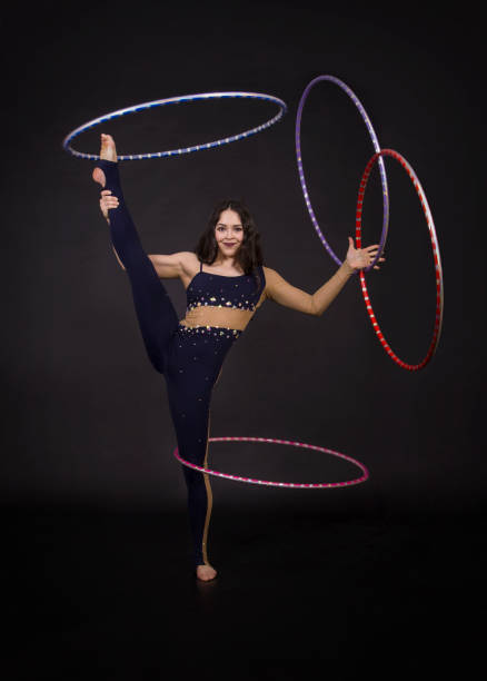 istock Gymnastic exercises with hula Hoop girl performs a circus artist. 961961676