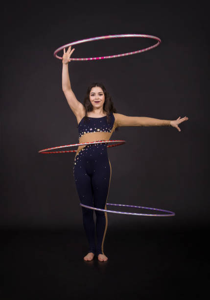 istock Gymnastic exercises with hula Hoop girl performs a circus artist. 961961730