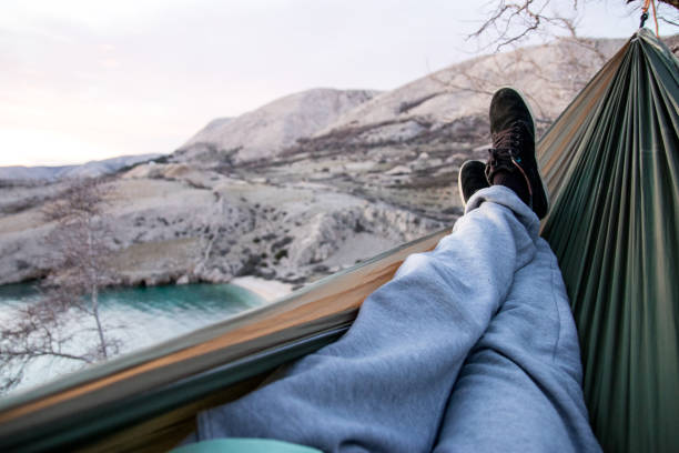 Man resting in hammock by the sea point of view