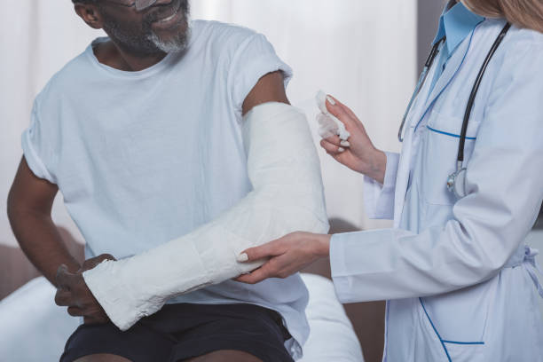 istock doctor bandaging patient hand 961966812