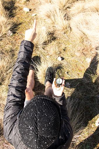 Guy Using A Compass Man Showing The Way Using The Compass From Above Stock Photo - Download ...