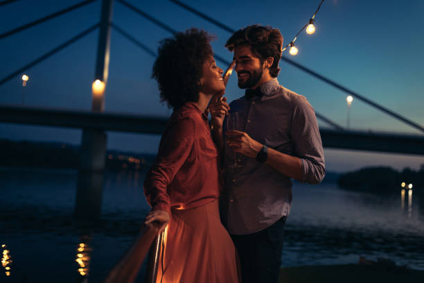 All I need is you Shot of young affectionate couple on a boat cruise date night romance stock pictures, royalty-free photos & images