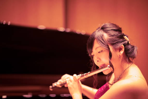 istock Young woman playing flute at concert 961999062