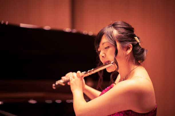 istock Young woman playing flute at concert 961999068